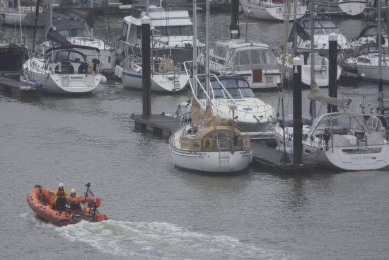 RNLI Dart B class lifeboat searching the harbour
